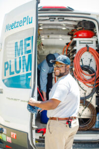 Meetze Plumber standing behind Meetze van