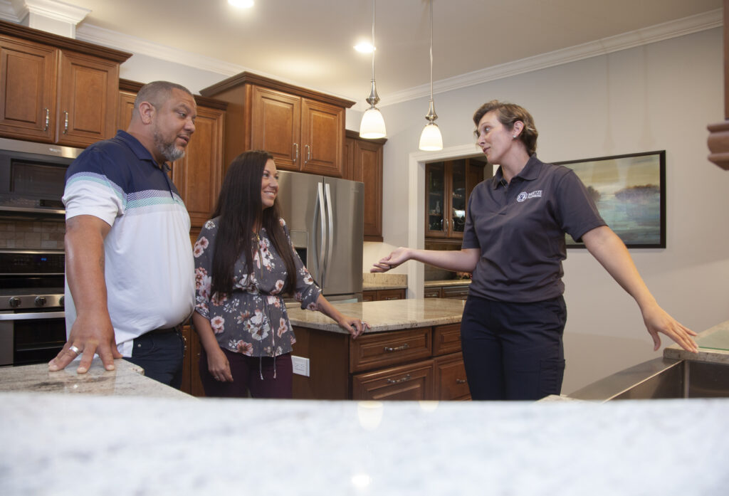 Meetze Plumbing Professionals Talking to Clients in Kitchen