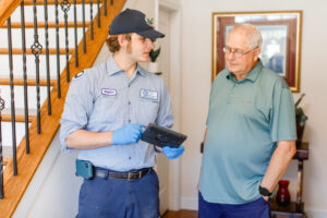 Meetze Plumber with Tablet Working with Client